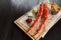 Cooked king crab legs with sauces and french fries