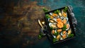 Cooked large green mussels with garlic, parsley and lemon on a metal tray. Seafood. Royalty Free Stock Photo