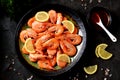 Cooked large shrimps with lemon, dill and tomato sauce. Healthy food. Top view. Royalty Free Stock Photo