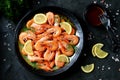 Cooked large shrimps with lemon, dill and tomato sauce. Healthy food. Top view. Royalty Free Stock Photo