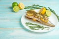 Cooked mackerel on a white plate with spices, herbs, lemon, lime and salt. Top view, space for copying, or menu Royalty Free Stock Photo