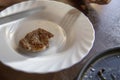 Cooked meat piece served on white ceramic plate placed on wooden table surface Royalty Free Stock Photo