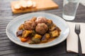 Cooked meatballs with stewed eggplant with haze in bowl