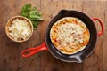 Cooked mozzarella and ham pizza on a skillet Royalty Free Stock Photo