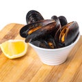 Cooked mussels in a bowl with lemon Royalty Free Stock Photo