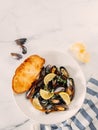 cooked mussels with lemon in white bowl Royalty Free Stock Photo