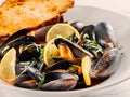 cooked mussels with lemon in white bowl Royalty Free Stock Photo