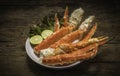 Cooked Organic Alaskan King Crab Legs with Butter and lemons, Alaskan King Crab on vintage wooden background. Royalty Free Stock Photo