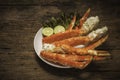 Cooked Organic Alaskan King Crab Legs with Butter and lemons, Alaskan King Crab on vintage wooden background. Royalty Free Stock Photo