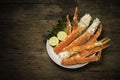 Cooked Organic Alaskan King Crab Legs with Butter and lemons, Alaskan King Crab on vintage wooden background. Royalty Free Stock Photo