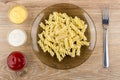 Cooked pasta fusilli in plate, different sauces and fork Royalty Free Stock Photo