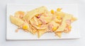 Cooked pasta with red onion, tuna and corn, white plate Royalty Free Stock Photo