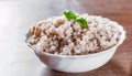 Cooked pearl barley in bowl on a wooden table Royalty Free Stock Photo