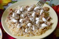 Cooked pilaf on the plate. With mayonnaise and ground black pepper. Oriental cuisine.