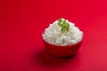 Cooked plain white basmati rice in a red bowl on red background Royalty Free Stock Photo