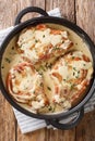 Cooked pork chops in creamy wine sauce with thyme close-up in a pan. Vertical top view Royalty Free Stock Photo