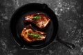 Cooked Pork Loin chops in rustic skillet, pan with rosemary. top view. background Royalty Free Stock Photo