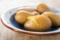Cooked potatoes on hand painted terracotta dish