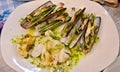 Cooked Razor Clams in green garlic sauce are cooked in olive oil and lemon Royalty Free Stock Photo