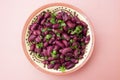 Cooked red beans plate on pink background, isolated. Healthy food Royalty Free Stock Photo