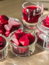 Cooked red slices beetroot in plate and glass bowls. Glass of beetroot juice