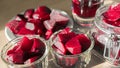 Cooked red slices beetroot in plate and glass bowls. Glass of beetroot juice