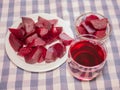 Cooked red slices beetroot in plate and glass bowls. Glass of beetroot juice