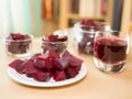 Cooked red slices beetroot in plate and glass bowls. Glass of beetroot juice