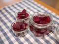 Cooked red slices beetroot in plate and glass bowls