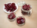 Cooked red slices beetroot in plate and glass bowls