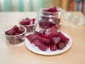 Cooked red slices beetroot in plate and glass bowls