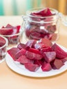 Cooked red slices beetroot in plate and glass bowls
