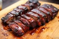 cooked ribs with char marks and bbq sauce