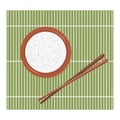 Cooked rice in a brown bowl on a green bamboo rug with Chinese chopsticks. Royalty Free Stock Photo