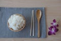 Cooked rice in a wooden bowl and spoon ,chopsticks on a wood background. Royalty Free Stock Photo