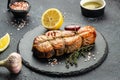 Cooked salmon steak with herbs, lemon, olive oil, Grilled fresh fish for healthy dinner, Restaurant menu, dieting Royalty Free Stock Photo