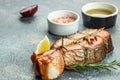 Cooked salmon steak with herbs, lemon, olive oil, Grilled fresh fish for healthy dinner, Restaurant menu, dieting Royalty Free Stock Photo