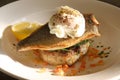 Cooked sea bass with a poached egg