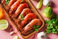 Cooked shrimp and langoustines, king prawns with lime, garlic and parsley. Grilled and fried on pink background Royalty Free Stock Photo