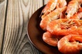 Cooked shrimp on a plate on a wooden background close-up Royalty Free Stock Photo