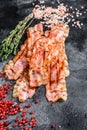 Cooked sizzling hot tasty crispy bacon. Black background. Top view Royalty Free Stock Photo