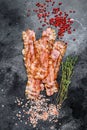 Cooked sizzling hot tasty crispy bacon. Black background. Top view Royalty Free Stock Photo