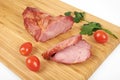 Cooked sliced pork barbecue steak on wooden cutting board on the white background Royalty Free Stock Photo