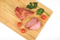 Cooked sliced pork barbecue steak on wooden cutting board on the white background Royalty Free Stock Photo