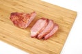 Cooked sliced pork barbecue steak on wooden cutting board on the white background Royalty Free Stock Photo