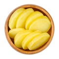 Cooked and sliced potatoes, thick potato slices in a wooden bowl