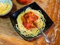 Cooked Spaghetti alla Sorrentina on old wooden table