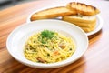 cooked spaghetti carbonara with a side of garlic bread Royalty Free Stock Photo