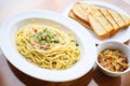 cooked spaghetti carbonara with a side of garlic bread Royalty Free Stock Photo