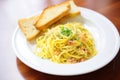 cooked spaghetti carbonara with a side of garlic bread Royalty Free Stock Photo